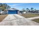 Newly painted house with blue garage door and a well-maintained lawn at 1407 Piney Branch Cir, Valrico, FL 33594