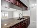 Modern kitchen with granite countertops and dark wood cabinets at 1407 Piney Branch Cir, Valrico, FL 33594