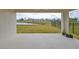 Covered patio overlooking a pond and grassy yard at 14825 Paddock Pond Ave, Lithia, FL 33547