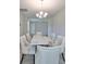 Dining room showcases a modern light fixture and table with seating for six in neutral colors at 14825 Paddock Pond Ave, Lithia, FL 33547