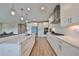 Modern kitchen with white cabinets, quartz countertops and stainless steel appliances at 14825 Paddock Pond Ave, Lithia, FL 33547