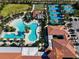 Aerial view showing resort-style pools, tennis courts, and clubhouse at 16847 Whisper Elm St, Wimauma, FL 33598