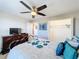 Bright bedroom with a ceiling fan and ample closet space at 16847 Whisper Elm St, Wimauma, FL 33598