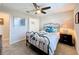 Cozy bedroom with metal bed frame, ceiling fan, and walk-in closet at 16847 Whisper Elm St, Wimauma, FL 33598