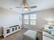 Bright bedroom with seating area and ceiling fan at 16847 Whisper Elm St, Wimauma, FL 33598