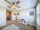 Spacious bedroom with ceiling fan and media console at 16847 Whisper Elm St, Wimauma, FL 33598