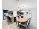 Dining area with round wooden table and six light-blue chairs at 16847 Whisper Elm St, Wimauma, FL 33598