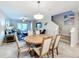 Round dining table with six chairs, located near kitchen and stairs at 16847 Whisper Elm St, Wimauma, FL 33598
