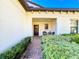 Inviting entryway with a seating area and brick pavers at 16847 Whisper Elm St, Wimauma, FL 33598