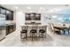 Modern kitchen with dark cabinetry, granite countertops, and breakfast bar at 16847 Whisper Elm St, Wimauma, FL 33598