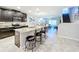 Open kitchen boasts granite counters, stainless steel appliances, and an island at 16847 Whisper Elm St, Wimauma, FL 33598