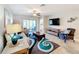 Comfortable living room featuring a sofa, armchair, and a large TV at 16847 Whisper Elm St, Wimauma, FL 33598