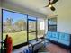 Spacious screened-in porch with comfy seating and a ceiling fan at 16847 Whisper Elm St, Wimauma, FL 33598