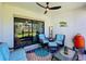 Cozy screened porch with seating area and a ceiling fan at 16847 Whisper Elm St, Wimauma, FL 33598