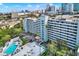 Enjoy this bird's eye view of the condominium's pool, outdoor seating, and city views at 201 W Laurel St # 308, Tampa, FL 33602