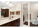 Bathroom with vanity sink, shower stall, and toilet, featuring a simple design at 201 W Laurel St # 308, Tampa, FL 33602