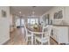 Bright dining room features hardwood floors and an oval wooden table with white chairs at 2283 Whisper Walk Dr, Spring Hill, FL 34606