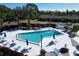 Community pool with lounge chairs, umbrellas, and a gazebo at 303 Knottwood Ct # 3, Sun City Center, FL 33573