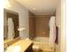 Bathroom with tub and shower, and brown vanity at 37715 Aaralyn Rd, Zephyrhills, FL 33542