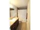 Bathroom with shower/tub combo and brown vanity at 37715 Aaralyn Rd, Zephyrhills, FL 33542