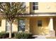 Inviting exterior of a two-story townhome with attractive landscaping at 37715 Aaralyn Rd, Zephyrhills, FL 33542