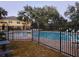 Community pool with surrounding patio furniture at 37715 Aaralyn Rd, Zephyrhills, FL 33542