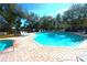 Octagonal community pool with plenty of lounge chairs at 37715 Aaralyn Rd, Zephyrhills, FL 33542