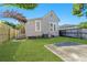 Nice backyard with a concrete patio, green grass, and access to a back entry at 408 E Amelia Ave, Tampa, FL 33602