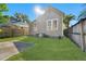 A cozy backyard featuring a concrete patio and green grass under the bright sun at 408 E Amelia Ave, Tampa, FL 33602