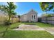 Lush backyard with green grass and a large concrete patio at 408 E Amelia Ave, Tampa, FL 33602