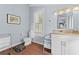 Cozy bathroom featuring a white vanity, granite countertop, neutral color scheme, and a window with natural light at 408 E Amelia Ave, Tampa, FL 33602