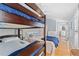 Bedroom with a bunk bed, dresser, and hardwood floors at 408 E Amelia Ave, Tampa, FL 33602