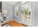 Bright entryway with hardwood floors, a decorative table, and a view to the front door and street at 408 E Amelia Ave, Tampa, FL 33602