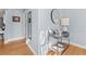 Hallway with natural light, hardwood floors, accent table and multiple mirrors at 408 E Amelia Ave, Tampa, FL 33602