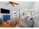 Inviting living room with a TV, hardwood floors, comfortable seating, and an open view of the kitchen at 408 E Amelia Ave, Tampa, FL 33602