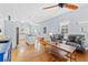 Comfortable living room with hardwood floors, a gray sofa, and seamless transition to the kitchen and dining area at 408 E Amelia Ave, Tampa, FL 33602