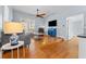 Bright living room featuring hardwood floors, comfy seating, and a large TV at 408 E Amelia Ave, Tampa, FL 33602