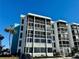 Condo building exterior, featuring light-colored walls and balconies at 4908 38Th S Way # 504, St Petersburg, FL 33711