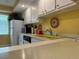 White kitchen cabinets, yellow countertops, and modern appliances at 4908 38Th S Way # 504, St Petersburg, FL 33711