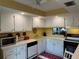 White kitchen cabinets, yellow countertops, and modern appliances at 4908 38Th S Way # 504, St Petersburg, FL 33711