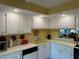 White kitchen cabinets, yellow countertops, and modern appliances at 4908 38Th S Way # 504, St Petersburg, FL 33711