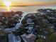 Wide aerial showcasing waterfront property and sunset at 5004 W Leona St, Tampa, FL 33629