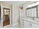Clean bathroom with a single vanity and access to the staircase at 5004 W Leona St, Tampa, FL 33629