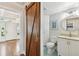 Clean bathroom with white cabinets and a barn door at 5004 W Leona St, Tampa, FL 33629