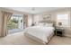 Lovely bedroom includes balcony access and windows with shutter shades allowing an abundance of light at 5004 W Leona St, Tampa, FL 33629