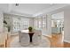 Light-filled dining area featuring a round table, stylish seating, and view into the kitchen at 5004 W Leona St, Tampa, FL 33629