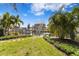 Waterfront property featuring a private dock, staircase to a rooftop deck and manicured landscaping at 5004 W Leona St, Tampa, FL 33629