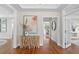 Elegant foyer featuring beautiful hardwood floors, glass table, and decorative artwork at 5004 W Leona St, Tampa, FL 33629