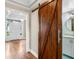 Hallway featuring a wooden sliding door into a bathroom and view of front door at 5004 W Leona St, Tampa, FL 33629