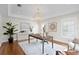Bright home office featuring hardwood floors, neutral colors, tray ceilings, and a stylish geometric light fixture at 5004 W Leona St, Tampa, FL 33629